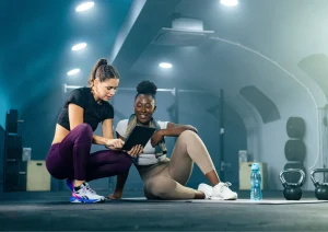 Image of a personal trainer and member looking at fitness trainer software