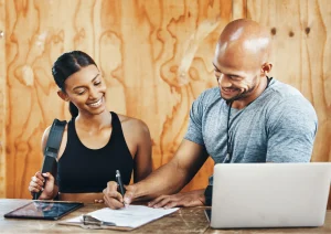 Image of a man and woman fulfilling legal requirements before opening a gym