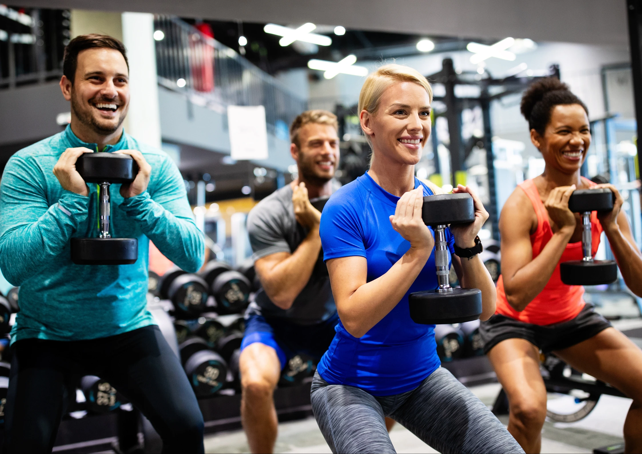 Image of gym members participating in a group fitness class
