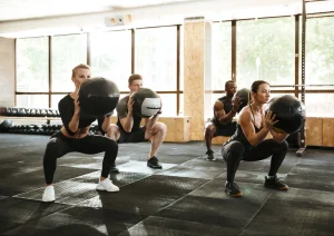 Image of gym members participating in a bodyweight exercise group class