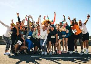 Image of a group of gym members cheering at a charity run