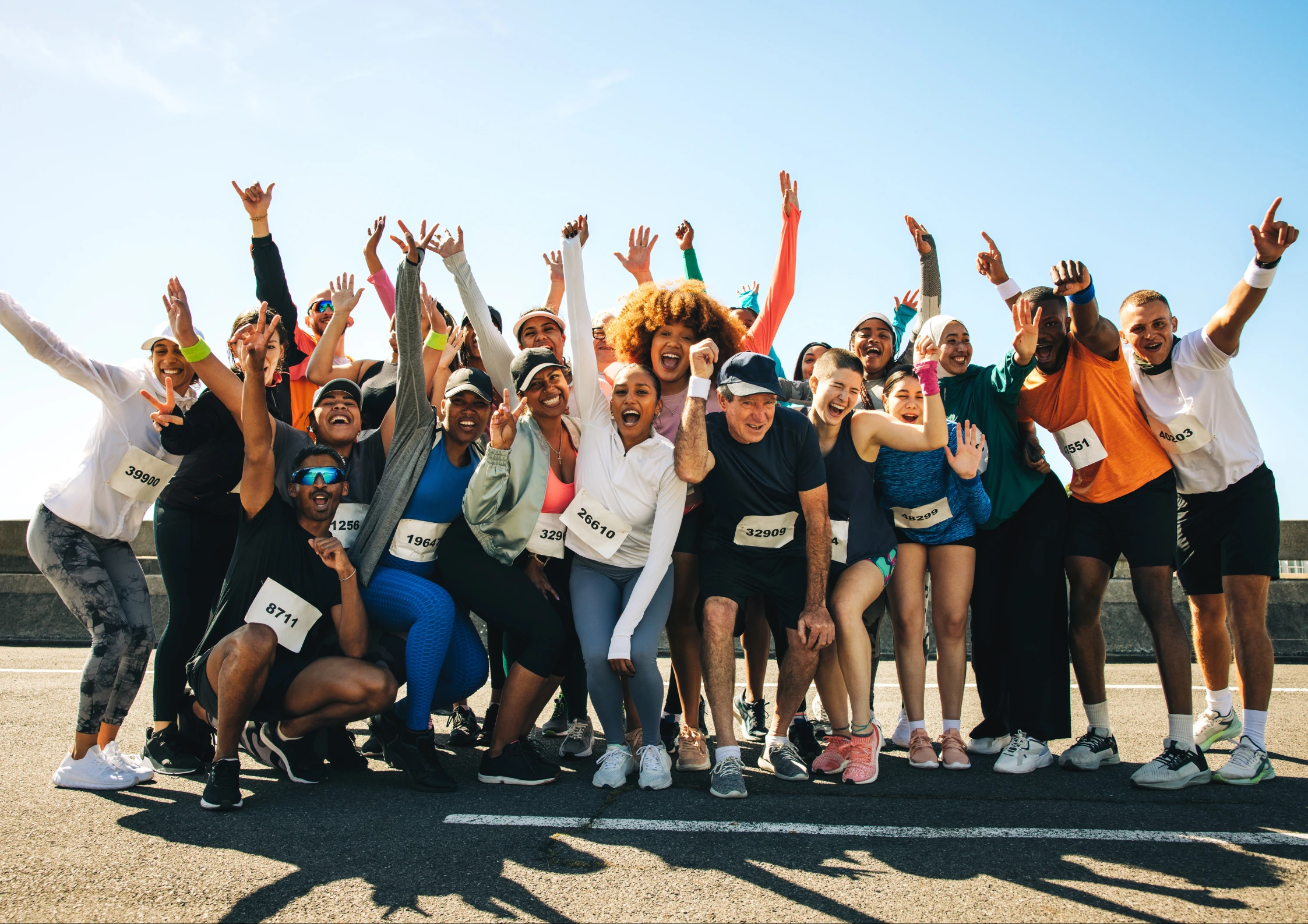 Image of a group of gym members cheering at a charity run