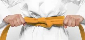 Image of a orange Taekwondo belt representing one of the Taekwondo belt levels and ranking system