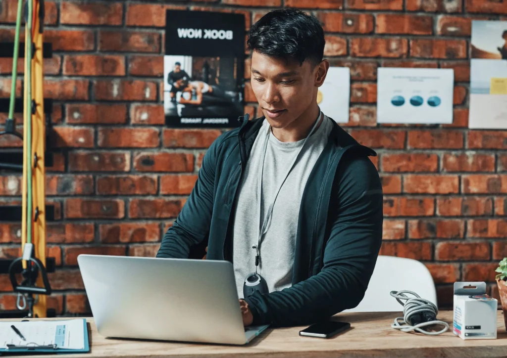 Image of a gym staff member using RhinoFit top gym management software at the gym