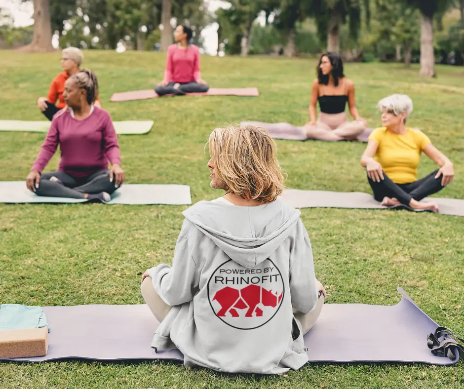 Image of an instructor from a yoga studio class teaching an outdoor class