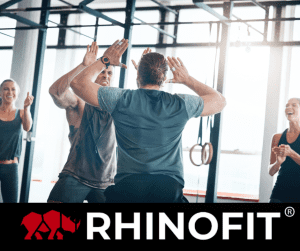 Image of 2 men high fiving at a gym event