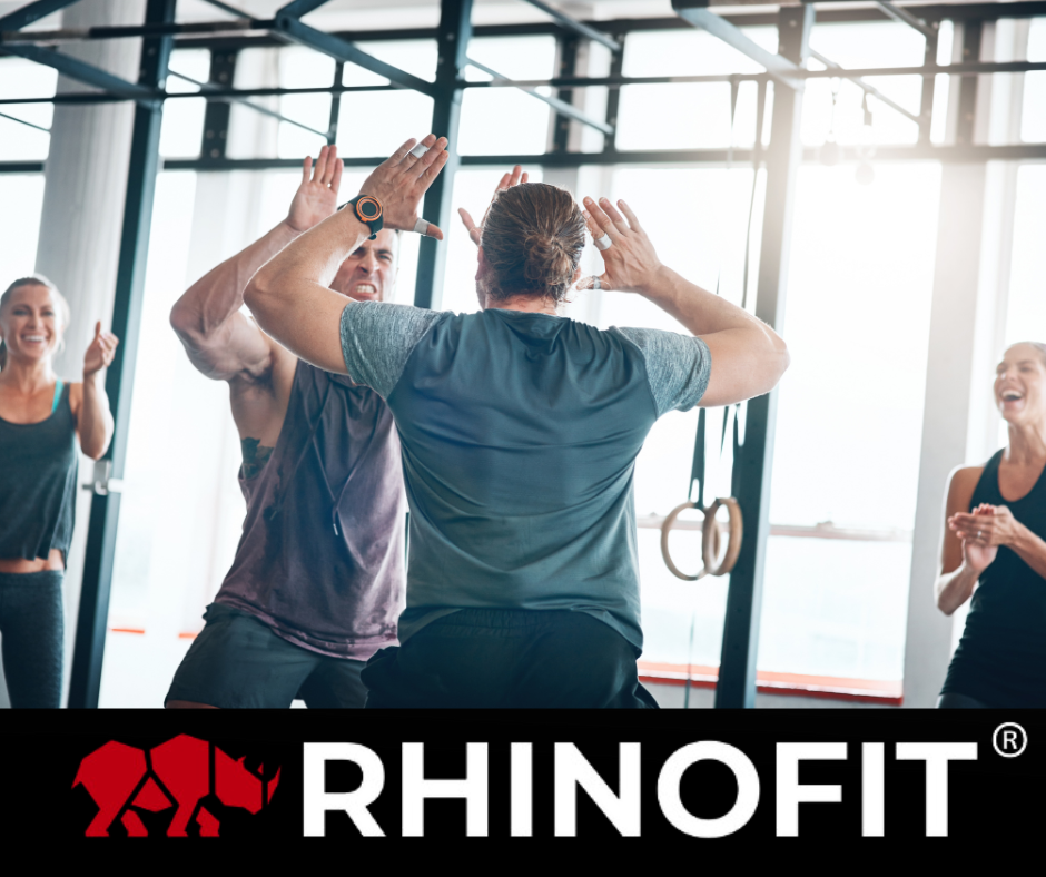 Image of 2 men high fiving at a gym event