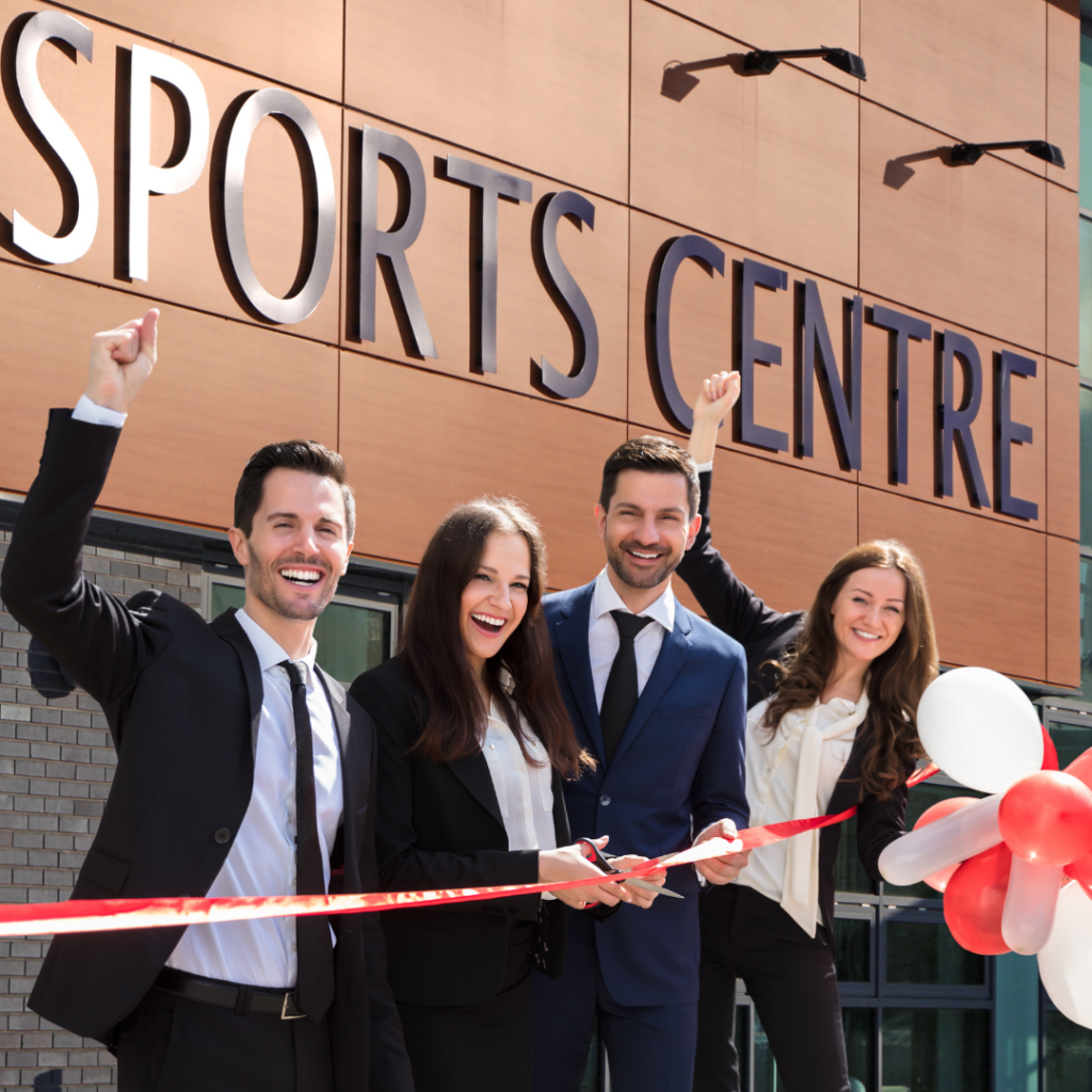 Image of gym owners hosting a grand opening for their gym launch