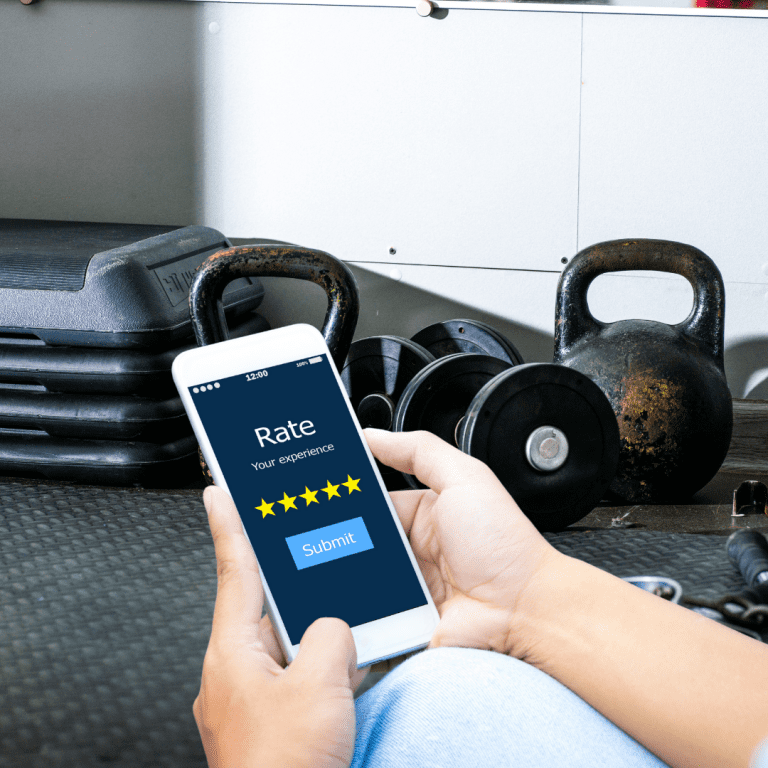 Image of phone with gym reviews on screen