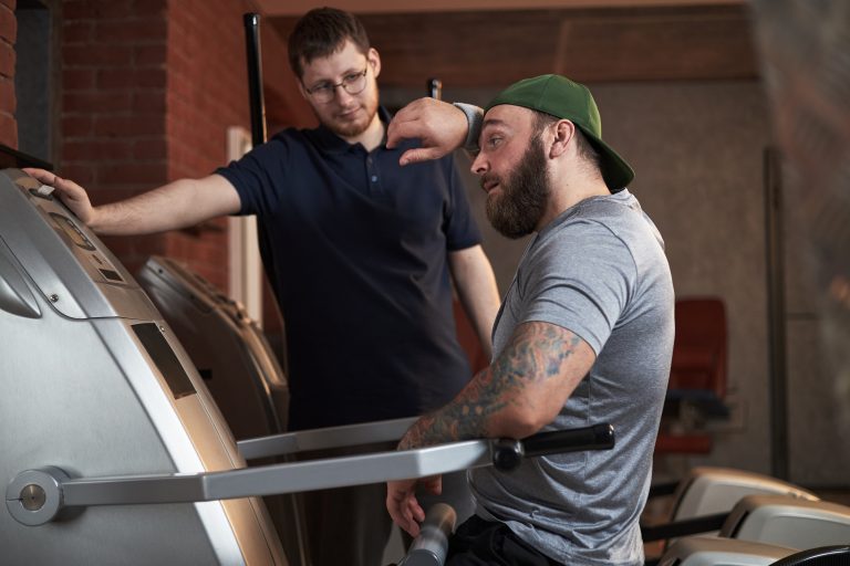 Image of gym staff trainer motivating a gym member