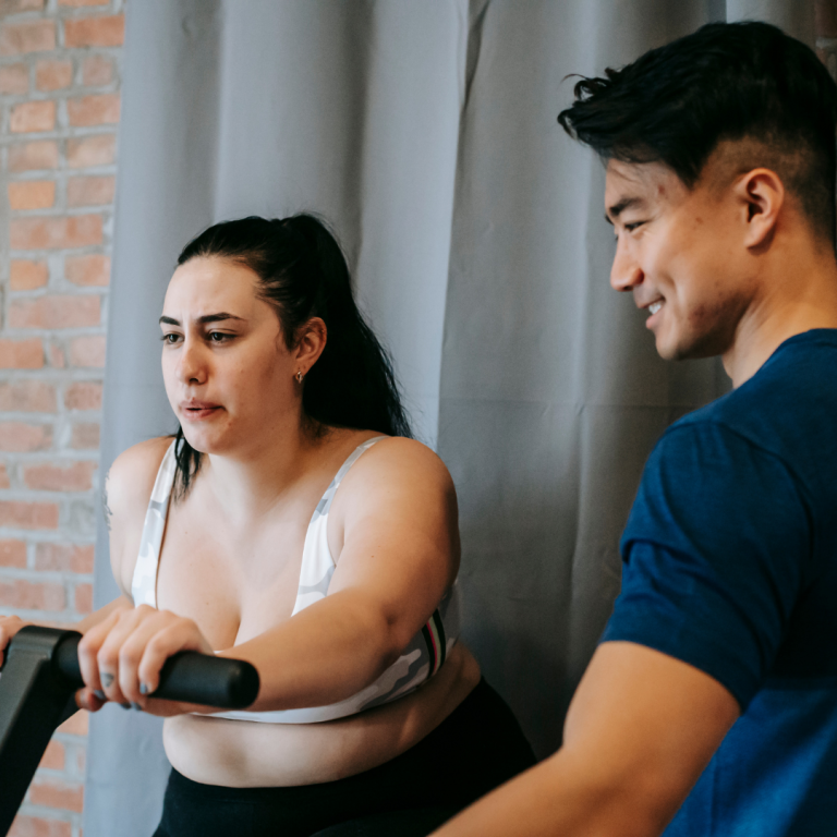 Image of an instructor helping out a member using cycling studio software Image of an instructor helping out a member using cycling studio software