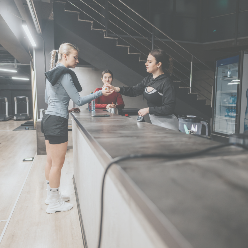 Image of gym staff helping out a gym member