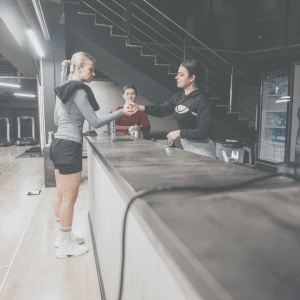 Image of gym staff helping out a gym member